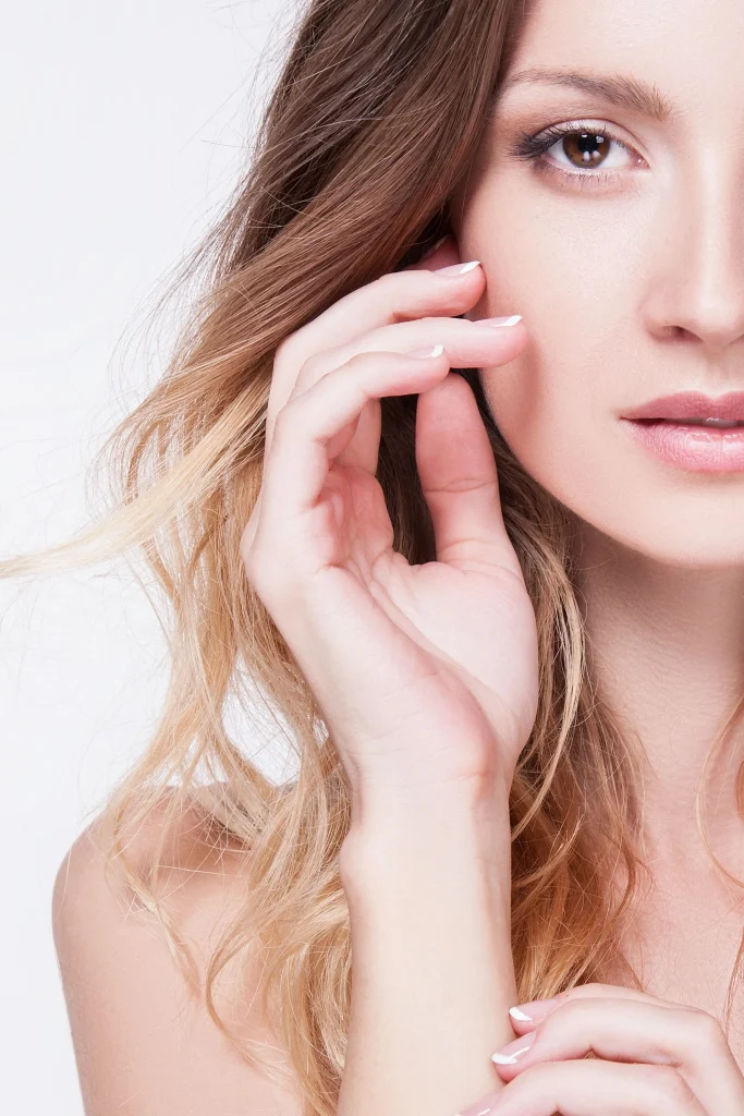 A woman touching her face.